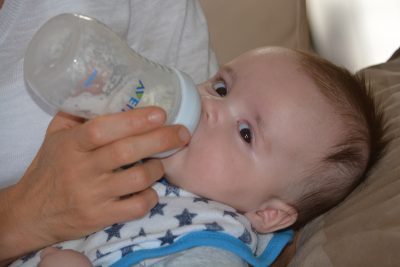 baby drinking formula bottle